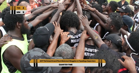 The quarter time huddle at the Tiwi Islands Grand Final - photo credit: ICTV