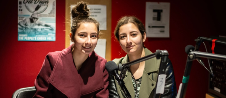 Two young girls in SYN FM studio
