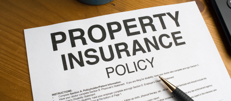 Property Insurance policy document overlayed with pen